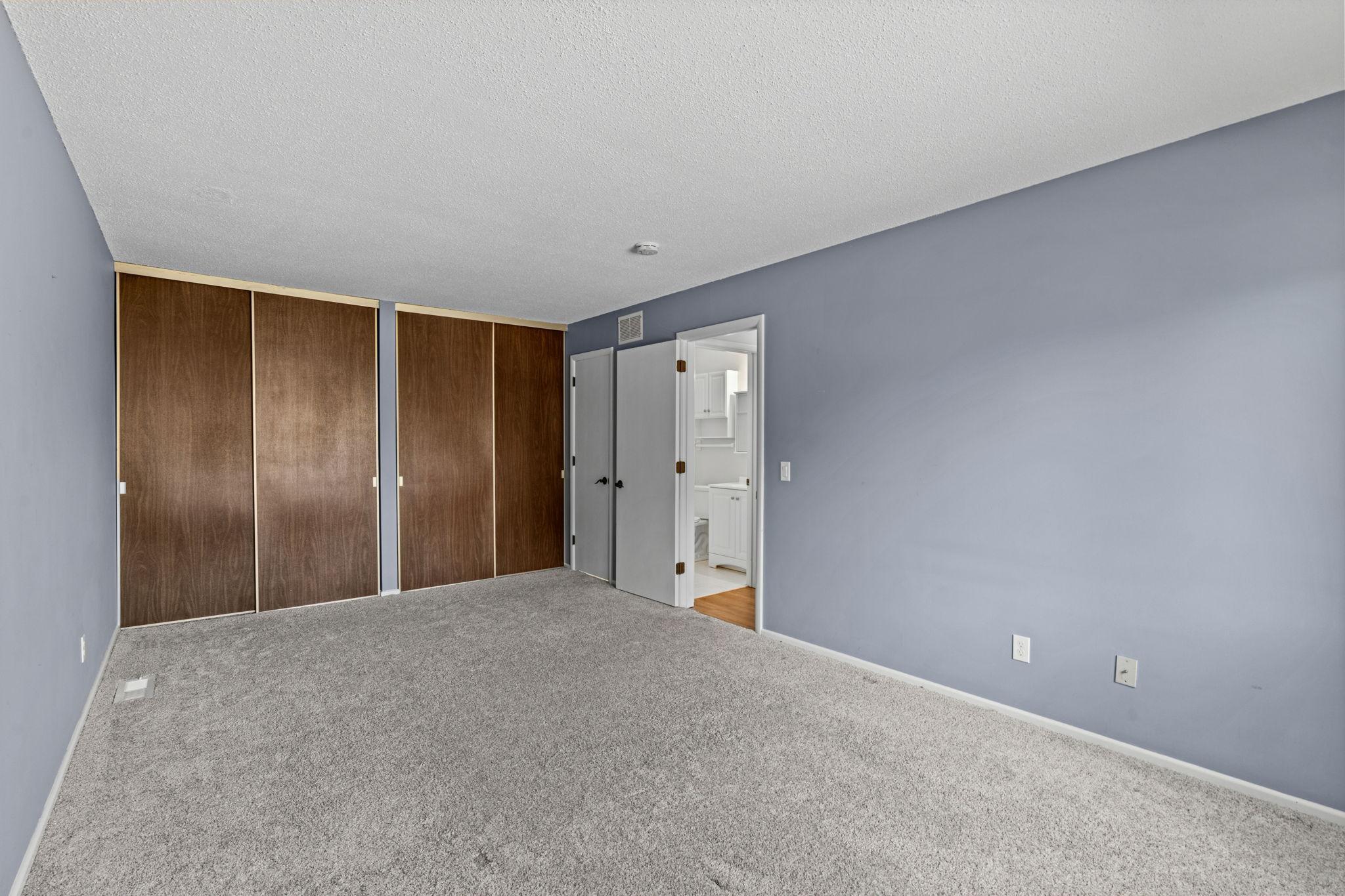 Wall to wall closet with private bathroom access