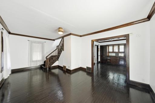 Beautiful 9 ft. ceilings, tall baseboards, crown molding, coved corners, oak stairwell banister, and gleaming maple floors!