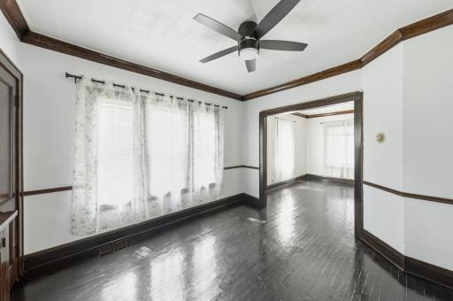 Large formal dining room with built in wall to wall hutch / buffet, lighted ceiling fan, and curtains and rods!