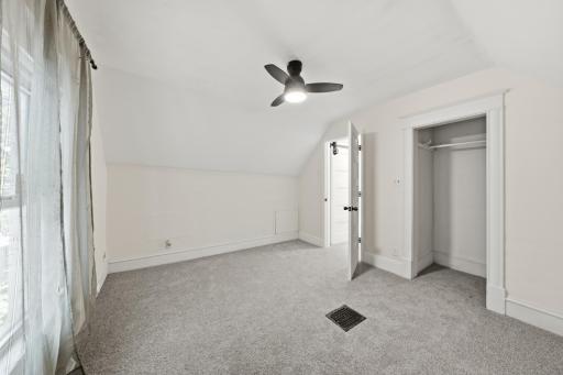 Bedroom 1 with new carpet, curtains, rods, and lighted ceiling fan!