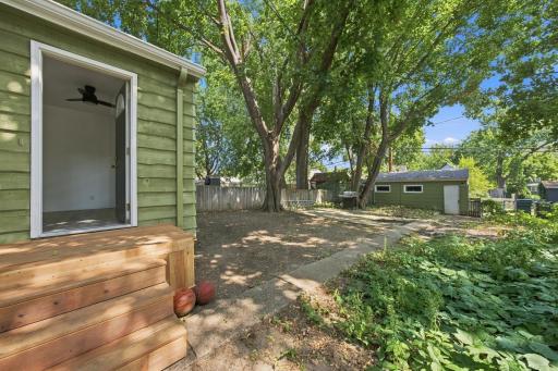 New steps / landing, large patio, trees, plants, freshly painted garage with a garage door opener, and all surrounded by a fenced in yard! Your own private retreat!