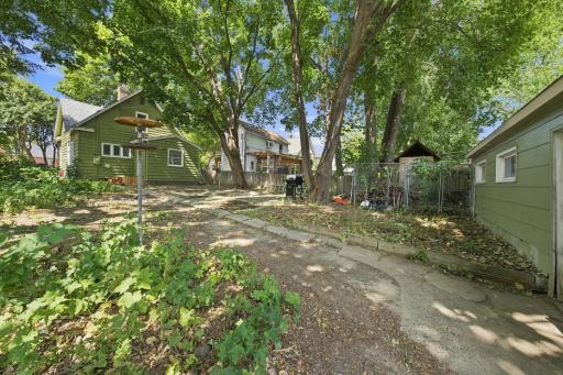 Private treed back yard with large patio and path winding from the garage to your new home!