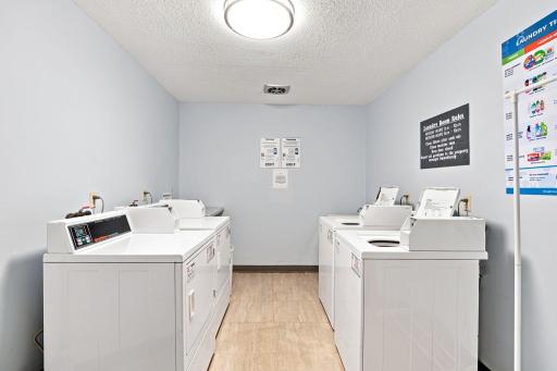 Clean, well-lit shared community laundry facility.
