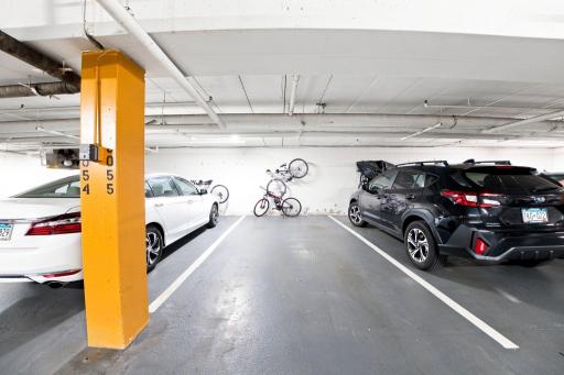 Heated underground garage with designated parking and hanging bicycle racks.