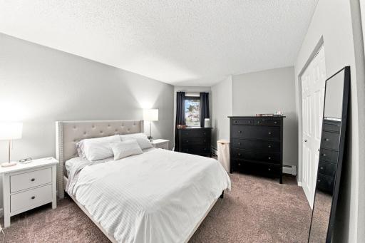 Spacious primary bedroom with beautiful natural light.