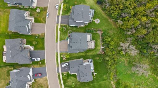 A bird’s-eye view captures the home, expansive outdoor living spaces, and the privacy that makes this setting so special.