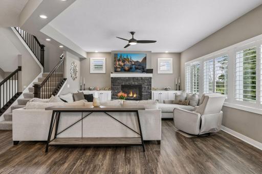 The fireplace makes a stunning focal point, framed by great windows and built-in cabinetry offering additional storage.