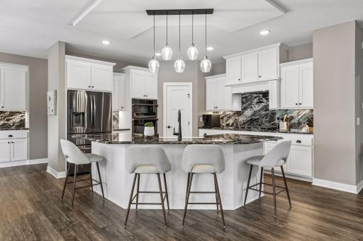 The oversized center island is truly the heart of this kitchen, offering incredible prep space and plenty of room to gather and entertain.