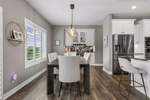 Another view of the dining area highlights the convenient dry bar with Oscuro Mist granite—a fantastic addition for entertaining.