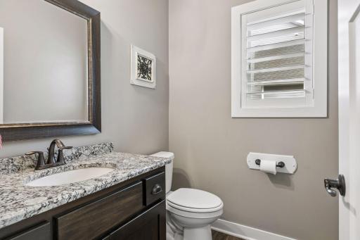 A convenient main-floor powder room is thoughtfully positioned for guests.