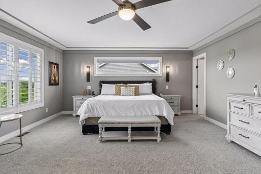 Thoughtfully placed windows bring beautiful natural light into the expansive primary bedroom.