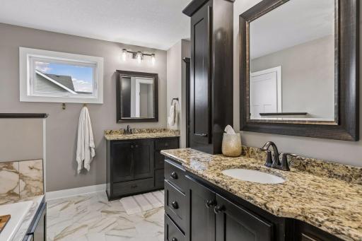 Dual vanities provide plenty of space and functionality in the spacious primary ensuite.