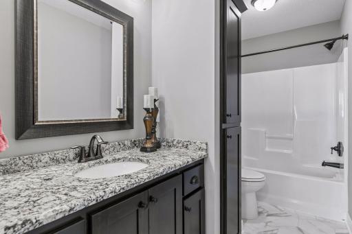 A second full bathroom on the upper level conveniently serves the additional bedrooms and loft.