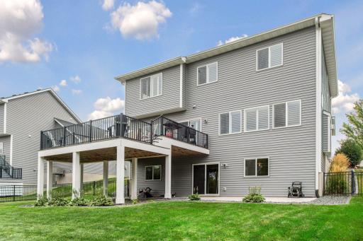 Looking back at the home, you can appreciate the two-tier deck, fully fenced backyard, and thoughtfully designed landscaping.
