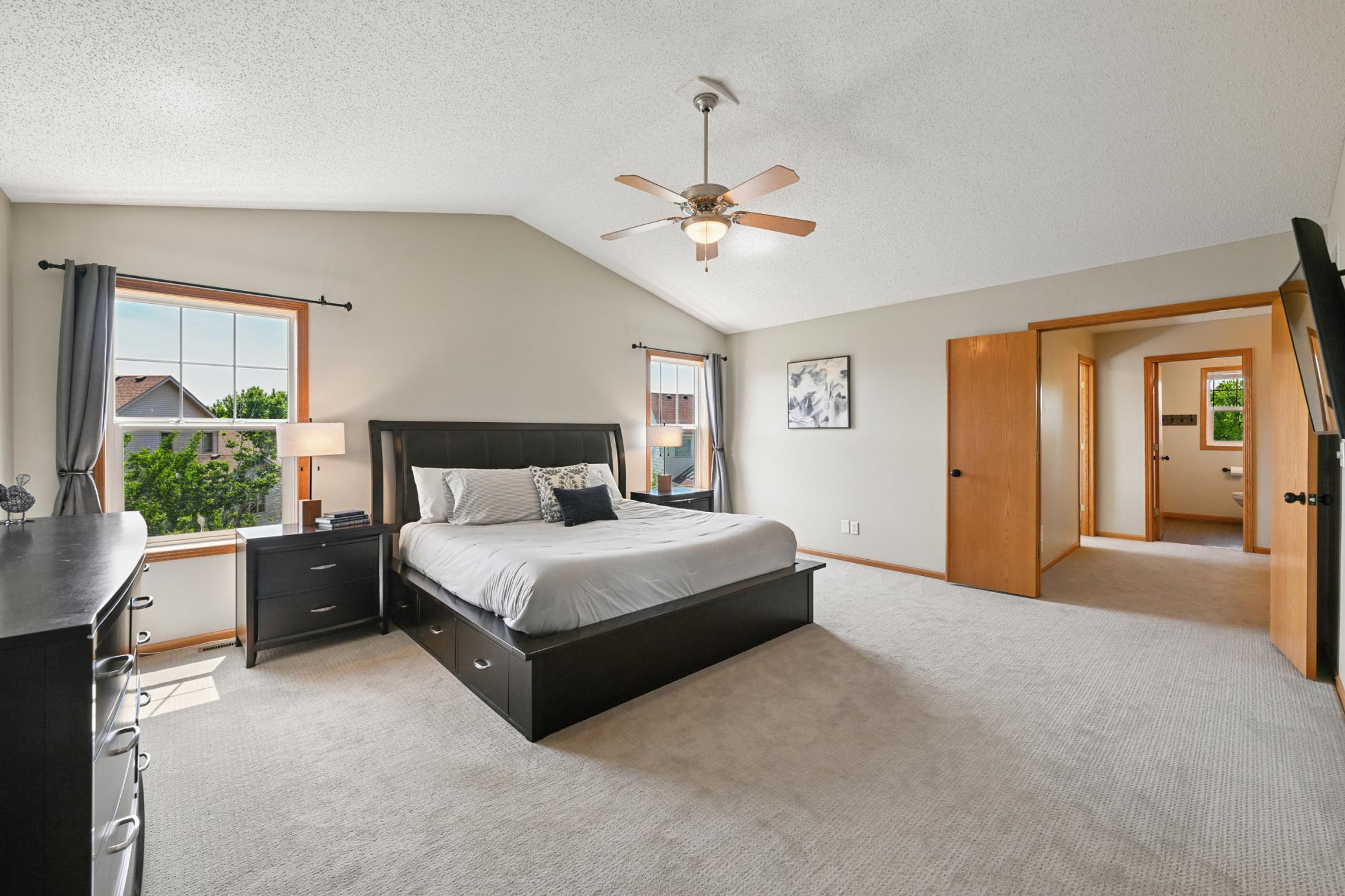 Primary suite with french doors and vaulted ceiling