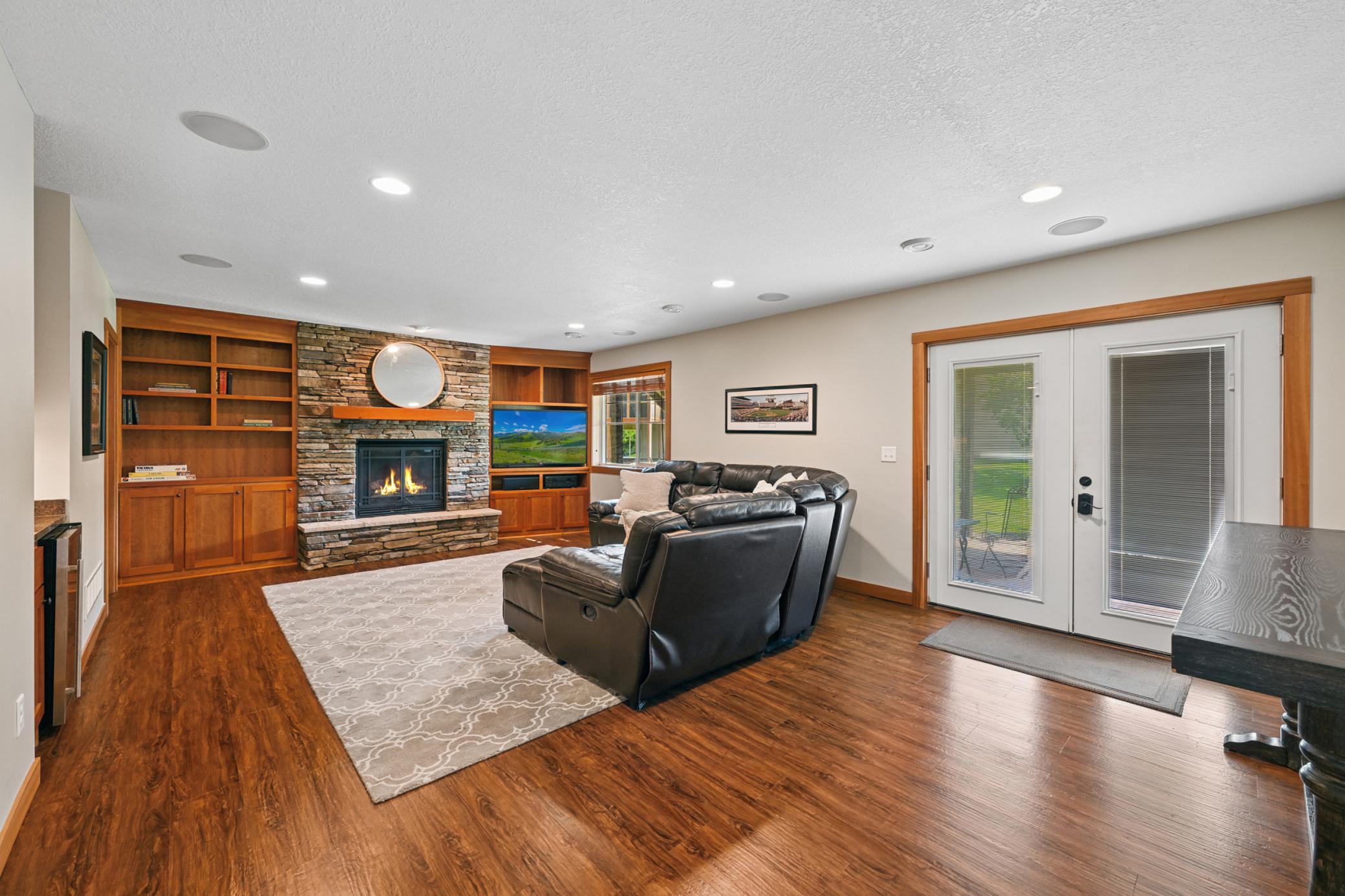 Fully finished walk out lower level with floor to ceiling stone fireplace