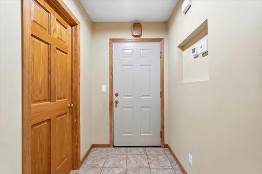 The entry leading to/from the garage offers space for shoes and easy access to the main floor bedroom.