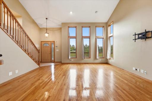 Soaring ceilings, hardwood floors and floor to ceiling windows makes for an inviting welcome.