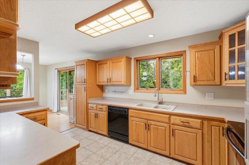 the kitchen and dining room look out to the private backyard