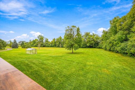 The beautifully maintained yard offers so much green space while being surrounded by trees-offering privacy