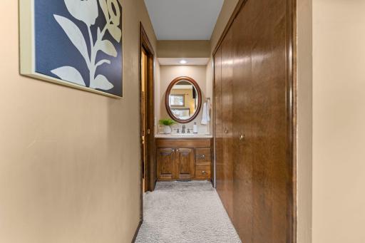 The primary suite has a separated vanity layout with the shower and toilet privately enclosed, while the vanity and sink are conveniently located just outside.