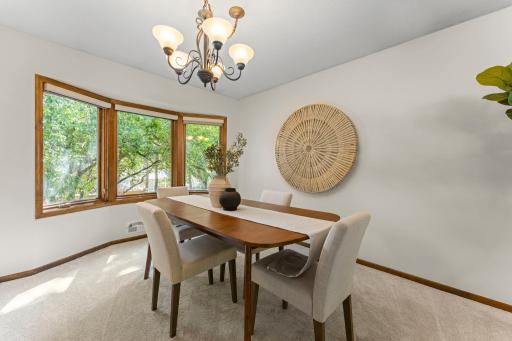 The dining room has an adorable bump out window showing off the beautiful backyard. It's large enough to fit a table for 10!