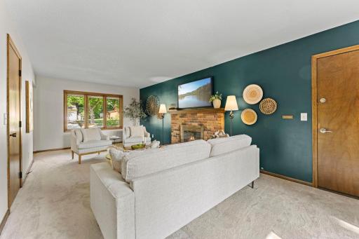 Yet another room filled with natural light with a large window on one side, and a patio door on the other.