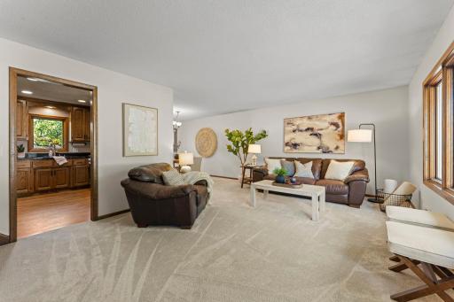 Another view showing the flow between the kitchen, living room, and formal dining room.