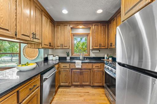 The kitchen has classic natural oak woodwork along with an updated counter top, appliances, sink, and hardware.