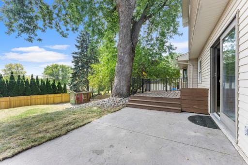 The concrete patio is the perfect place to sit and soak in the private backyard.