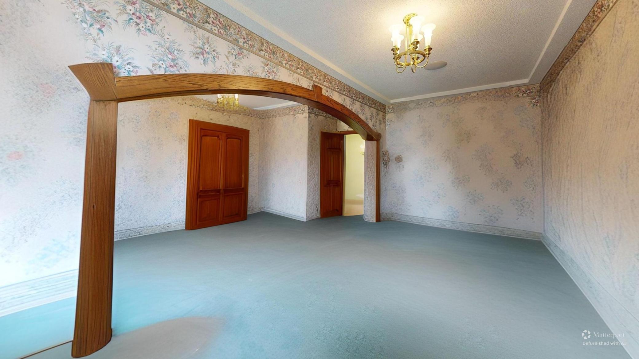 Spacious bedroom with furnishings digitally removed highlighting arched woodwork, distinctive character details, and flexible layout potential