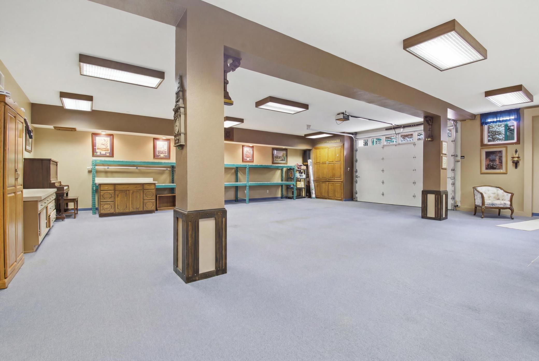 Expansive finished lower-level flex/garage space with multiple potential uses.
