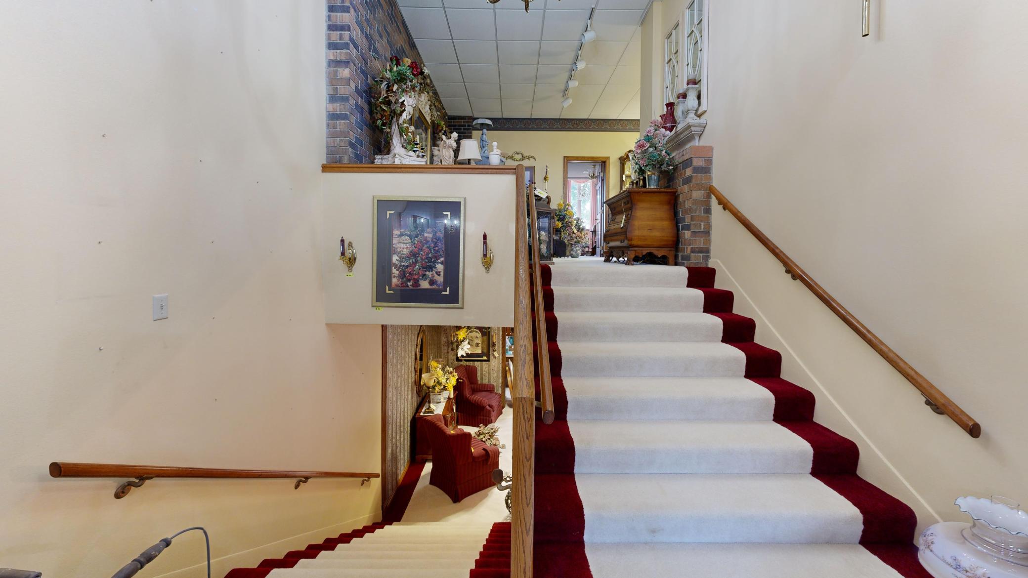 Split-level stairway from main entrance connecting the upper and lower levels of the property