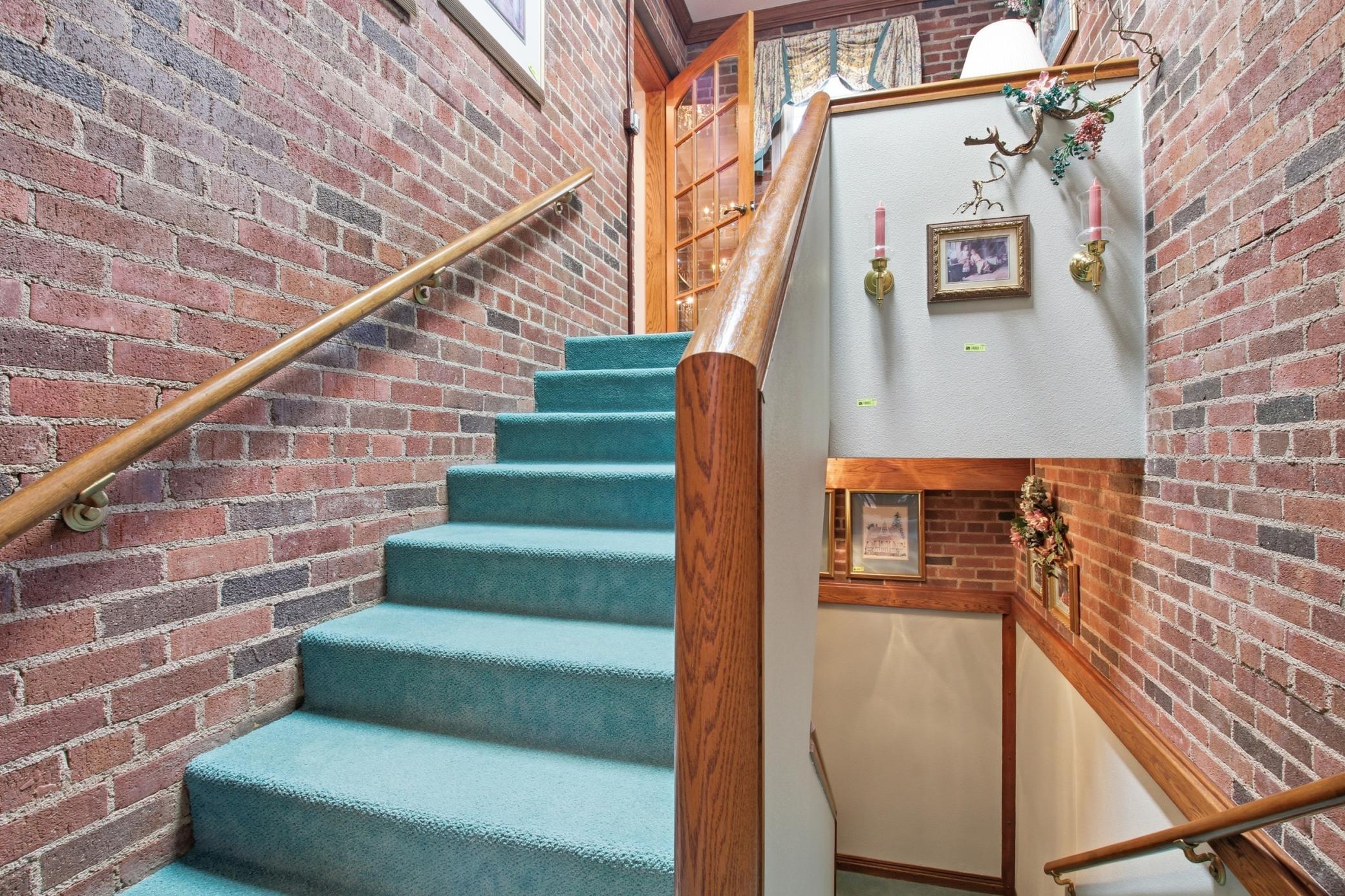 Split-level stairway from side entrance connecting the upper and lower levels of the property.