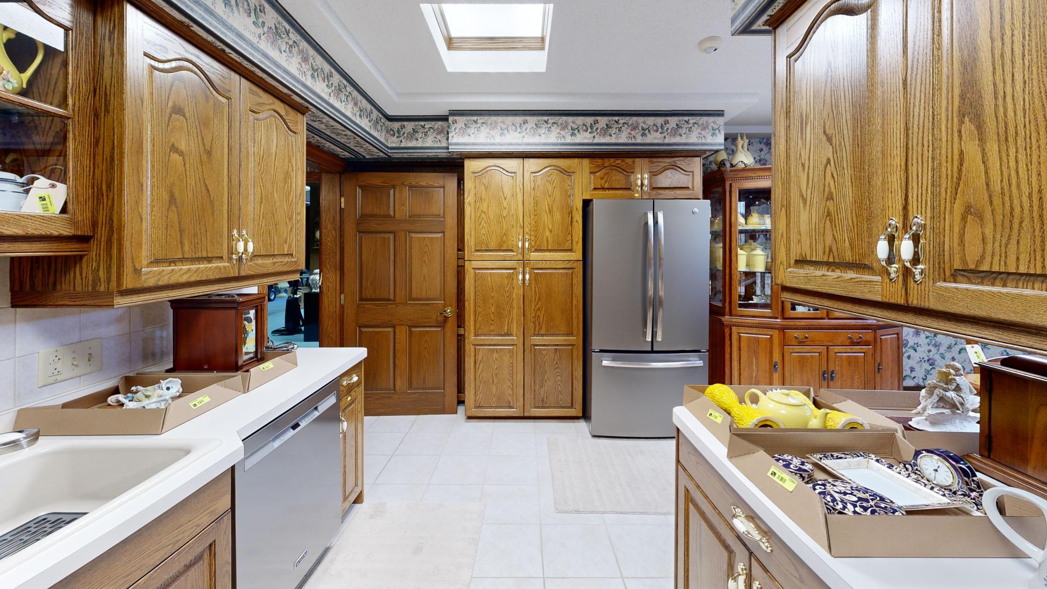 Spacious kitchen/dining with generous cabinetry, functional layout potential, and gas fireplace