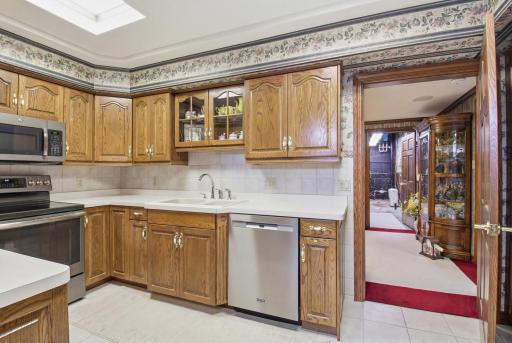 Spacious kitchen/dining with generous cabinetry, functional layout potential, and gas fireplace