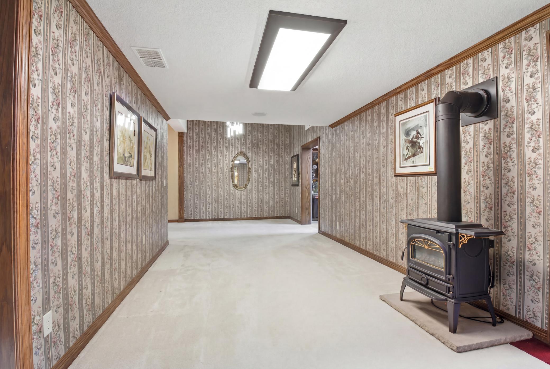 Additional finished lower-level flex space with open layout and adjoining rooms