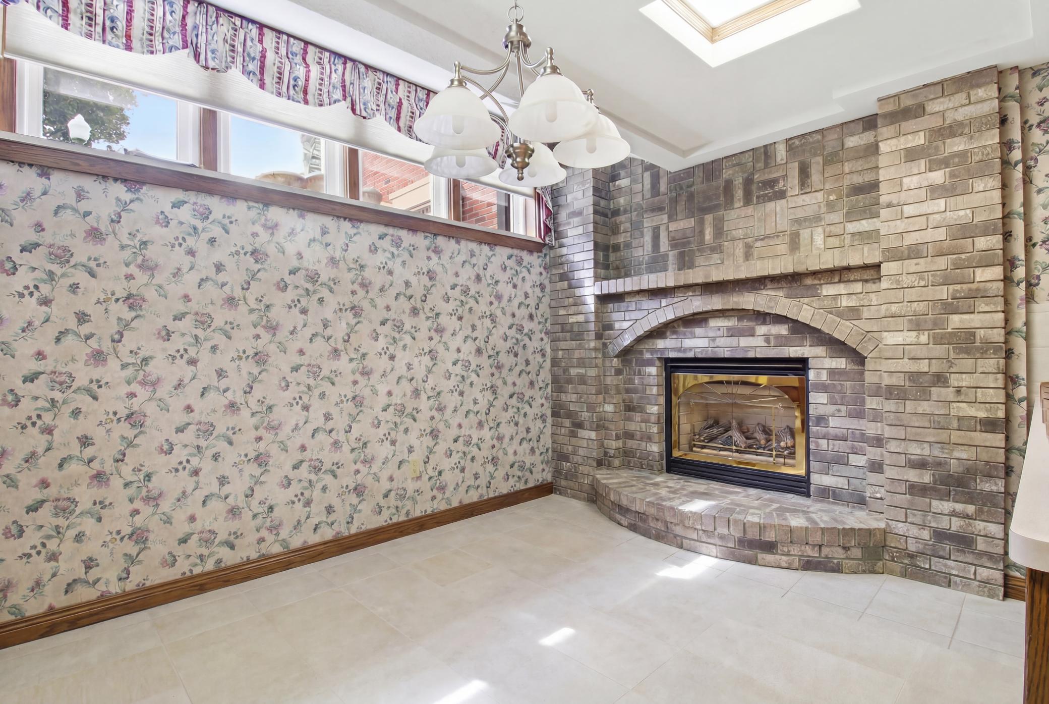 Dining area with gas fireplace and and natural light