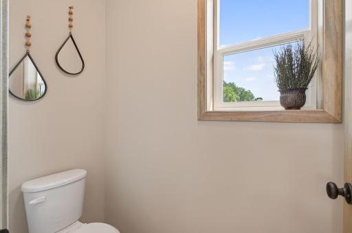 The toilet is set in it's own water closet and has a single hung window for light and ventilation.