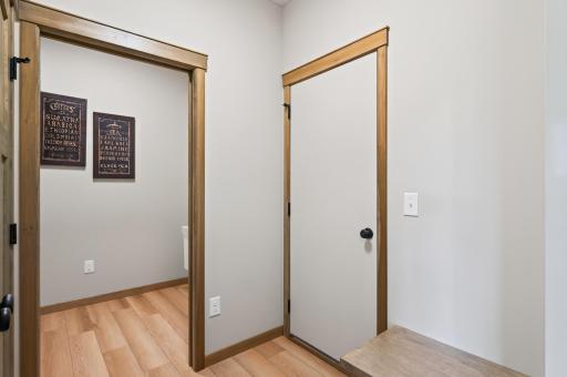 A view from the mudroom looking towards the laundry room. There is a nice built in bench in the mudroom.