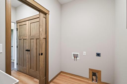 The laundry room has a pocket door, easy care LVP flooring, water hook ups for the washing machine, venting and a 220 volt plug in for an electric dryer.