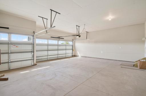 There is a 3 car garage with a garage door opener on the main stall side and a wireless keypad outside.