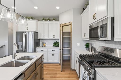Desirable corner pantry closet with lots of space for your canned and boxed goods.