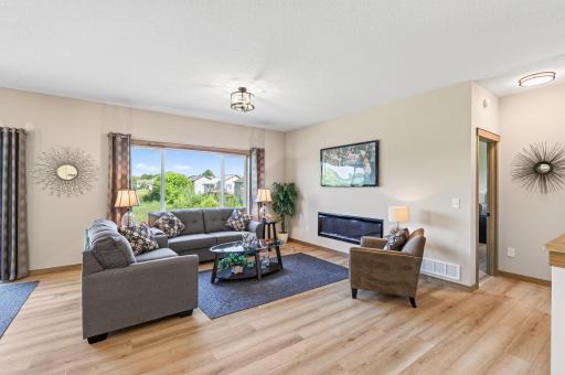 Great room with Allusion platinum electric fireplace and oversized 3 wide glider window for lots of natural light.