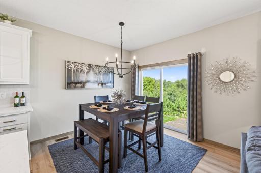 Informal dining area off the kitchen with a sliding glass door the opens to a future deck.
