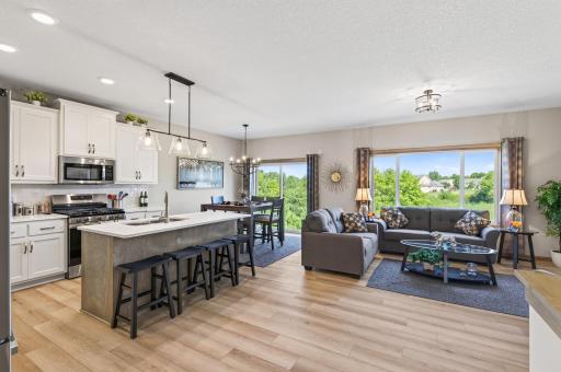 Great gathering plan design with kitchen, informal dining and great room all open. Easy care LVP flooring throughout the traffic area's.