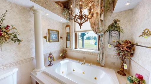 Spacious bath with soaking tub, skylight, and natural light