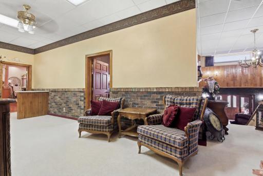Lower-level built-in serving area with custom cabinetry, adjacent full bath, and generous storage