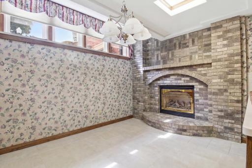 Dining area with gas fireplace and and natural light