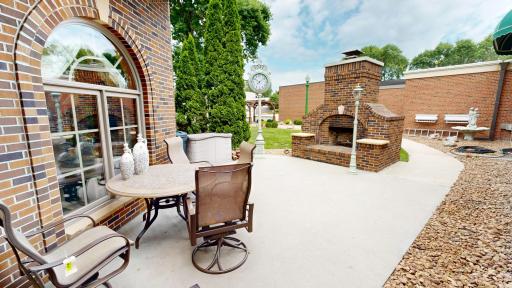 Inviting patio with wood-burning fireplace.